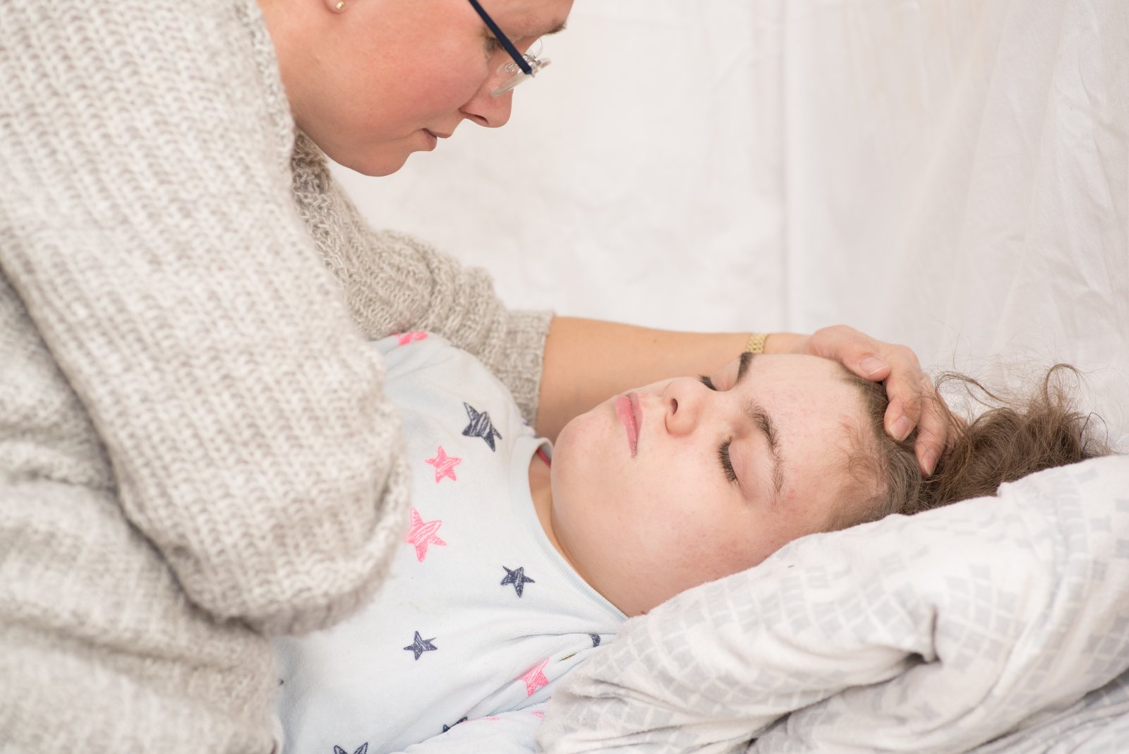 A mother comforts her resting child