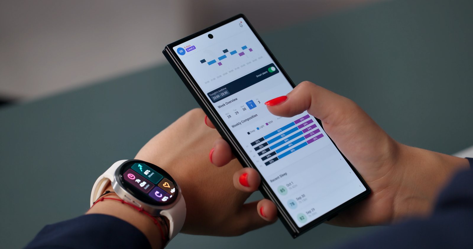 A person checking health metrics on a smartwatch and phone