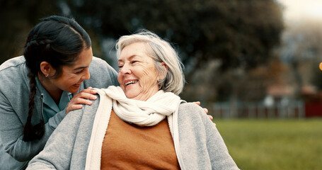 Two women laughing together outdoors